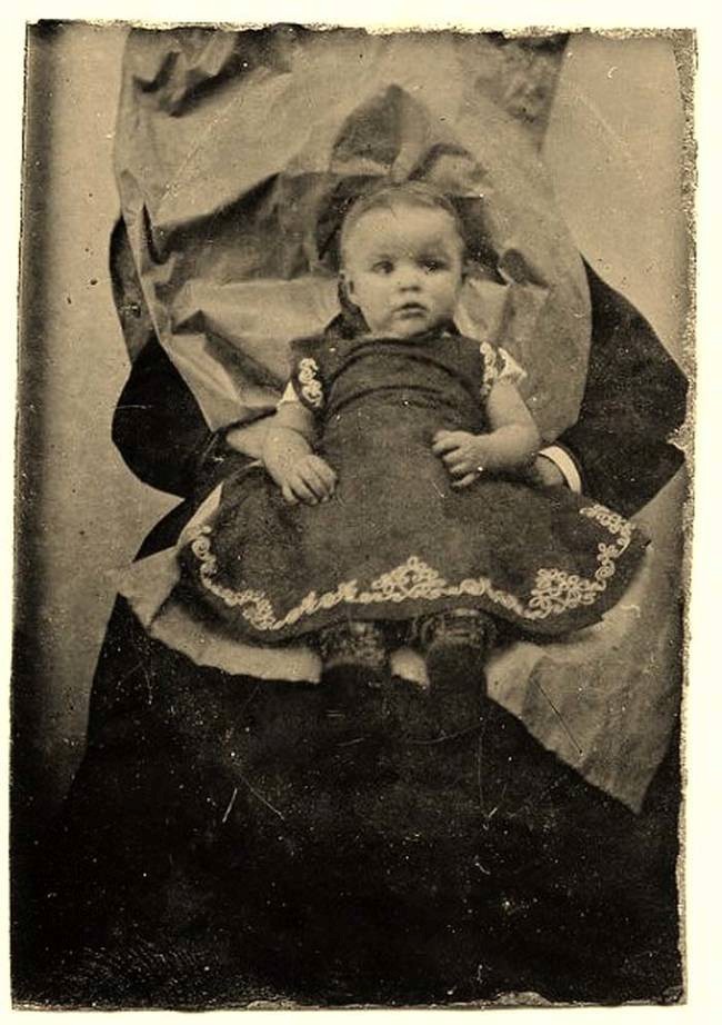 Babies sit on the laps to prop them up like a normal baby would look like